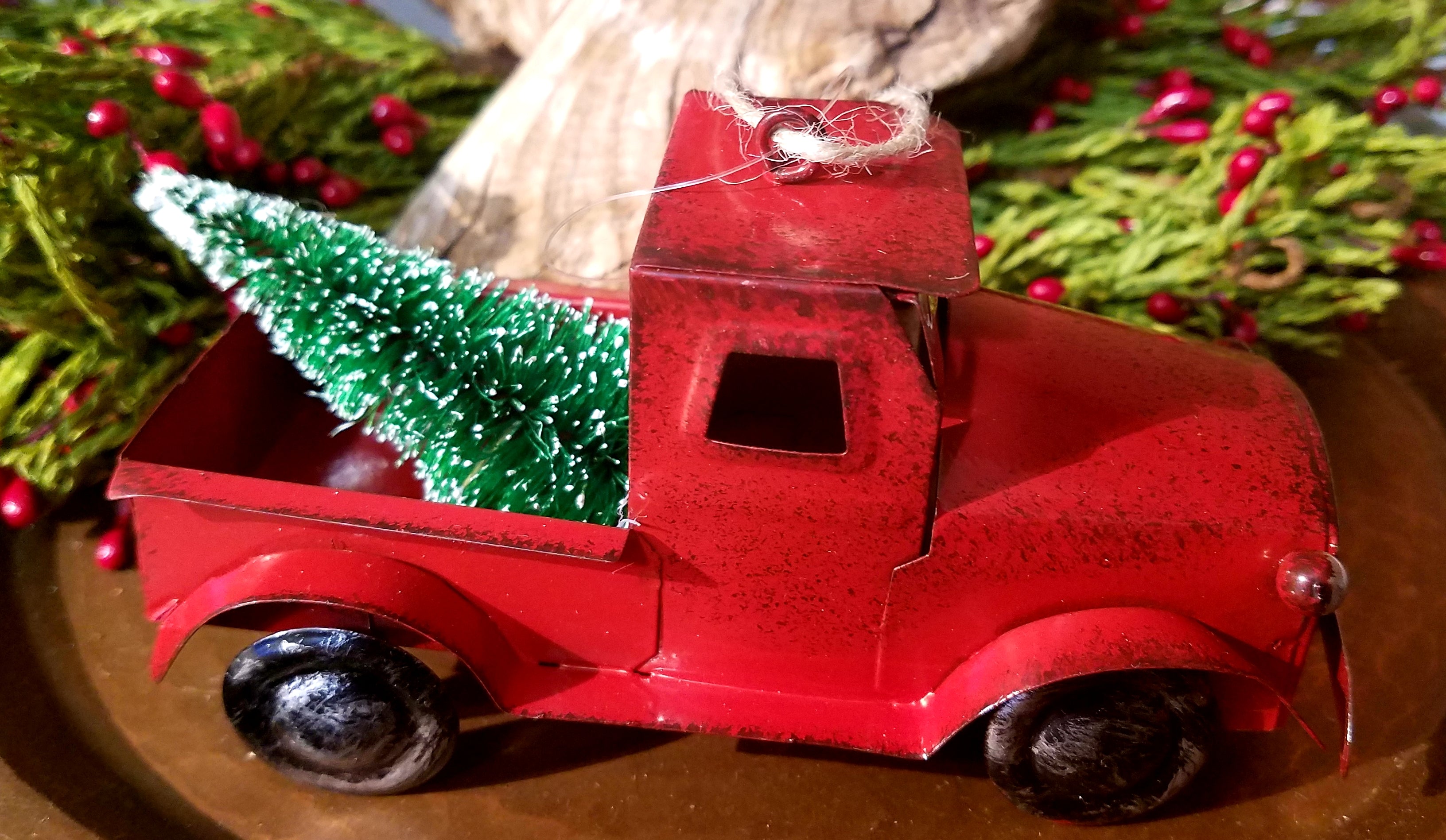 red metal truck ornament with tree in bed